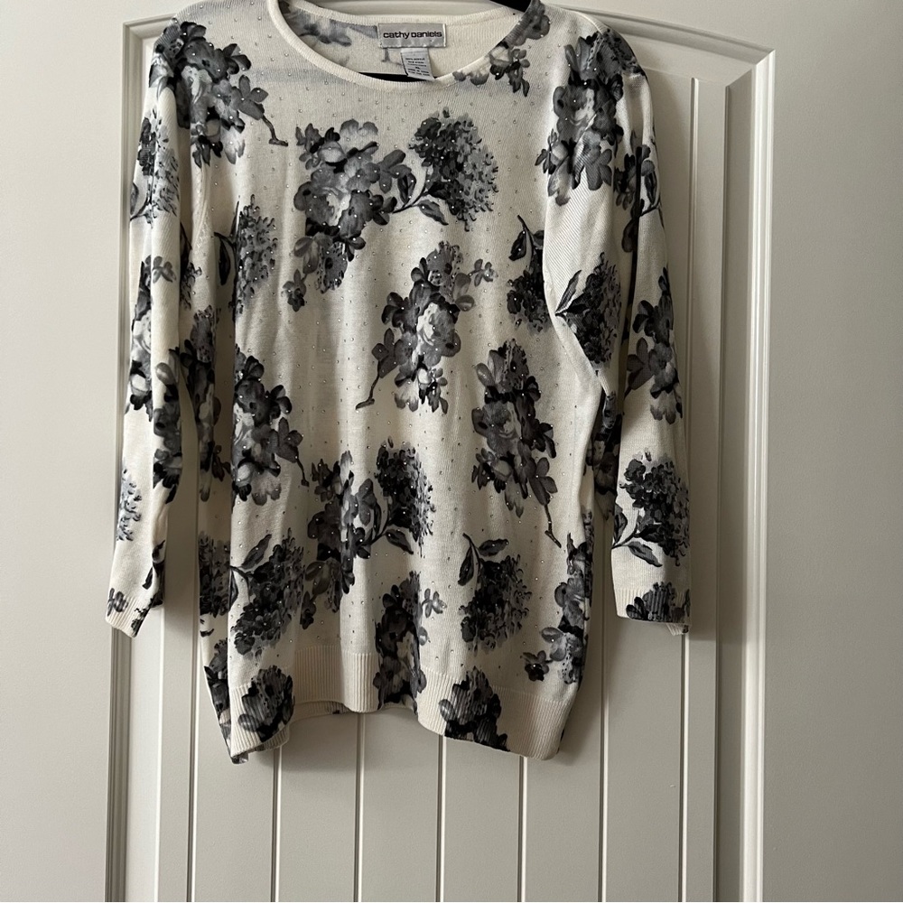 Lightweight sweater top. Very sweet. Cream with black flowers and rhinestones